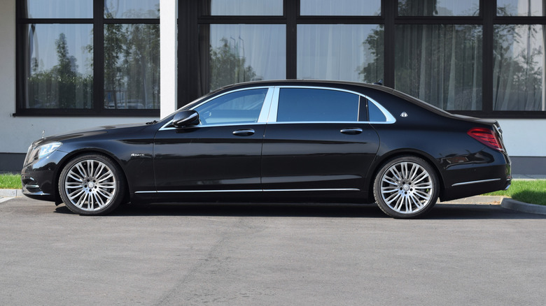 A black Mercedes-Maybach S600 parked on the street.
