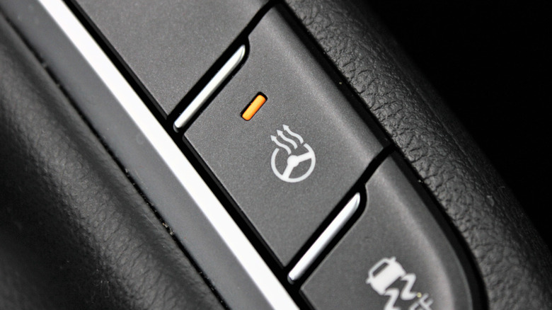 A closeup of a button to enable the heated steering wheel feature