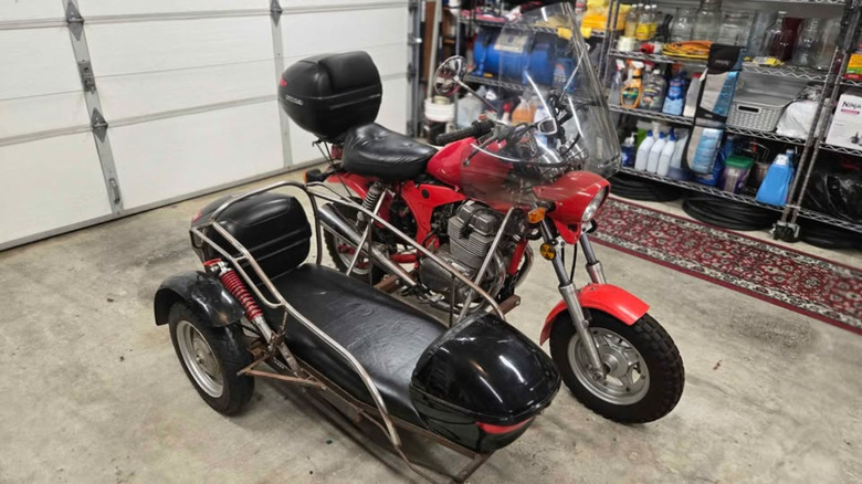 Red Honda custom bike with black sidecar