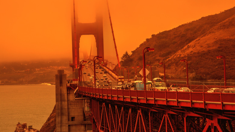 Cars on the Golden Gate Bridge shrouded in wildfire smoke.