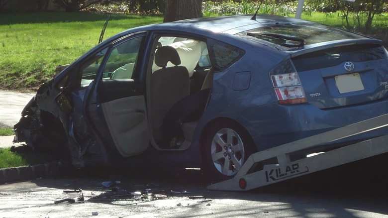 A crashed Toyota Prius with the airbags deployed.