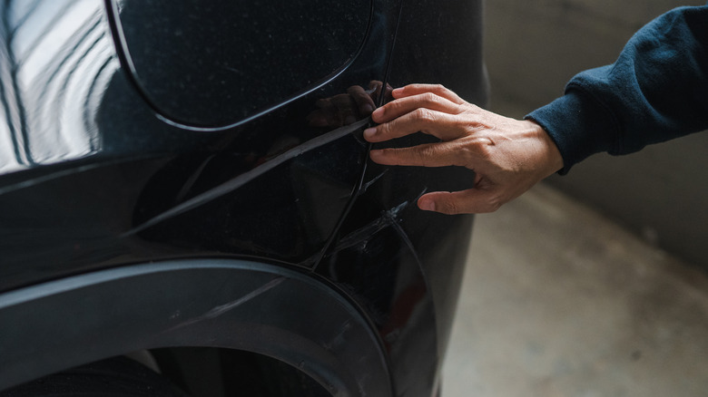 An noticeable scratch on a black car