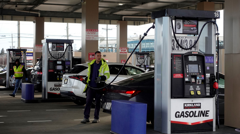 Attendant filling up a car at a Costco gas station