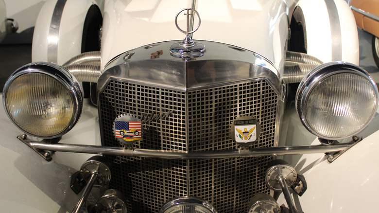 A cream-colored Excalibur SS seen head-on