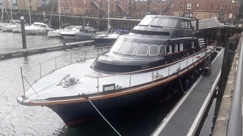 A yacht named Brave Challenger sitting peacefully in a dock after a good restoration.