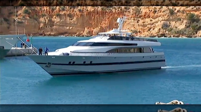 A yacht named Foners cruising through the marina of the coast of Spain.