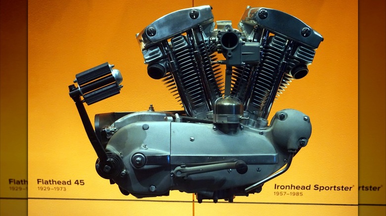 An Ironhead Sportster engine sits against an orange background.