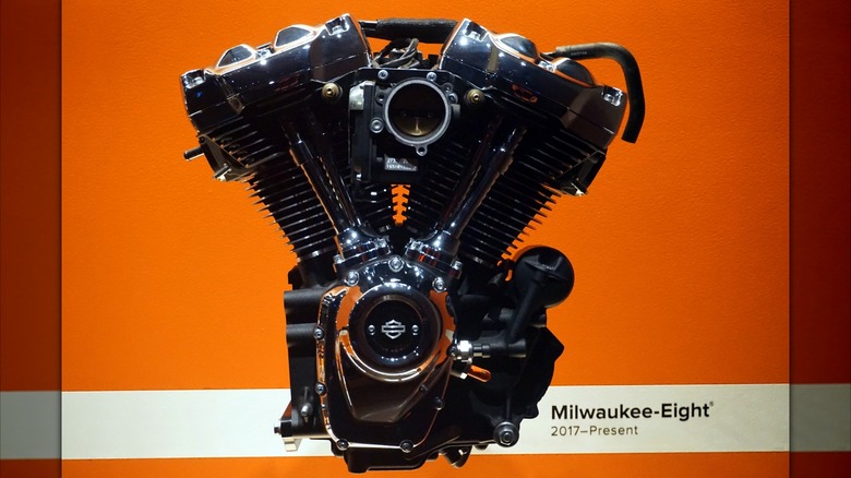 A Harley-Davidson Milwaukee-Eight sits against an orange background.