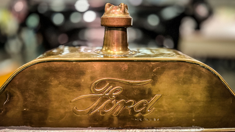 A Ford logo embossed on a metal plate.
