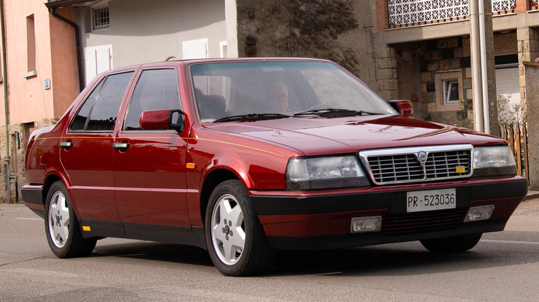 A red Lancia Thema 8.32 parked unassumingly on the road