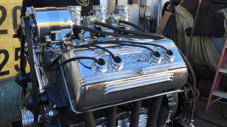 A vintage Ford flathead V8 engine with a modern Ardun conversion