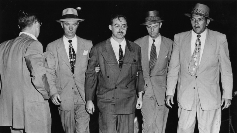Julius Rosenberg, center, being taken into custody by the FBI in 1950