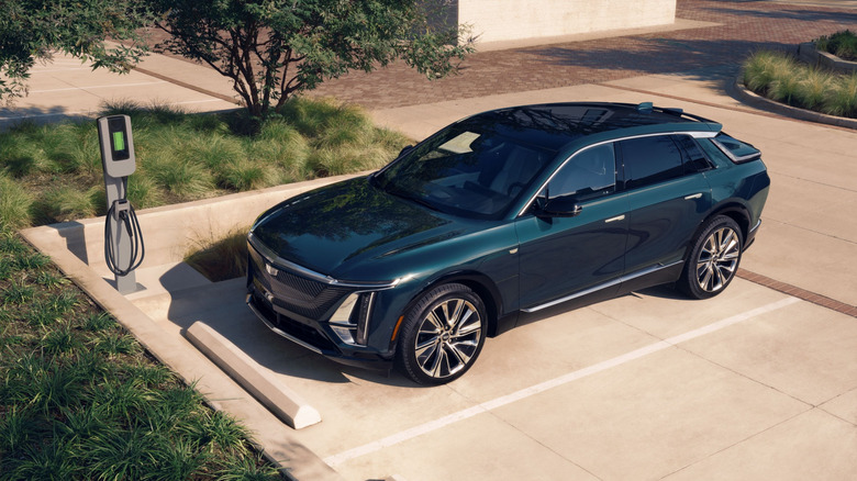 Elevated 3/4 front view of 2026 Cadillac Lyriq parked near charger