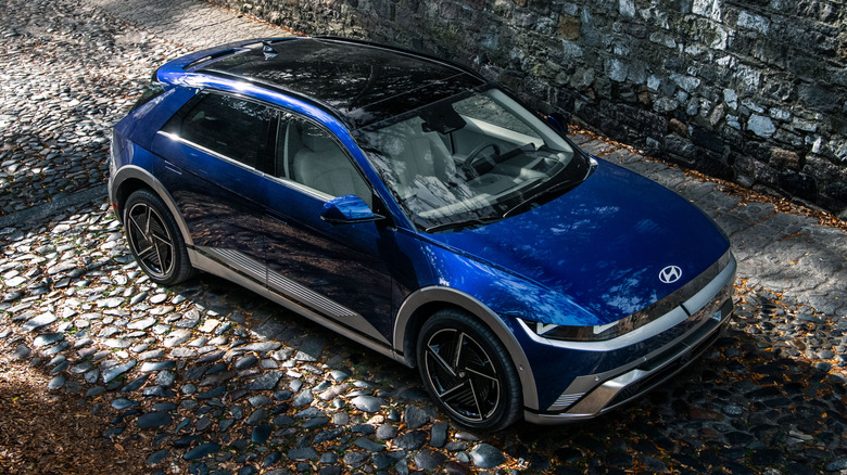 An elevated front 3/4 of a 2026 Hyundai Ioniq 5 parked on a cobblestone alley