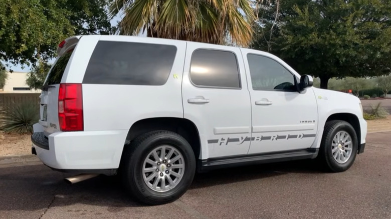 A rear 7/8 of a white Chevrolet Tahoe two-mode hybrid