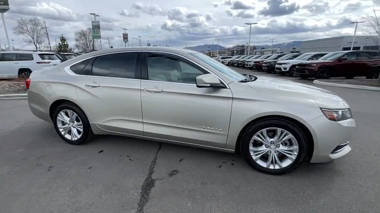 A 2014 Chevrolet Impala LT Eco in Champagne Silver on a used-car lot