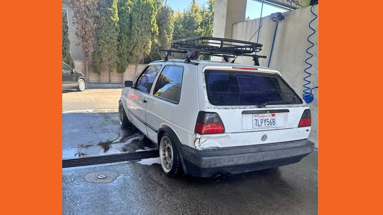 White GTI from the rear in a wash bay