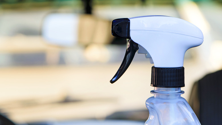 A close-up of a spray bottle in a car.