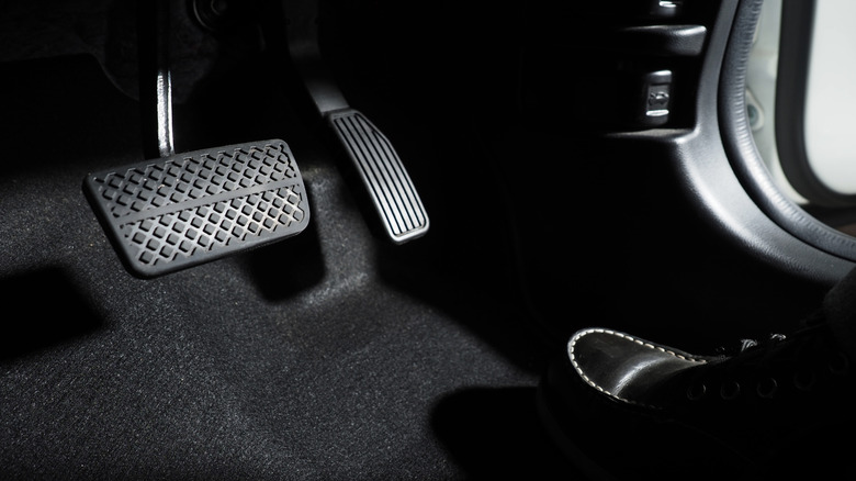 An image of an accelerator and brake pedal in a car