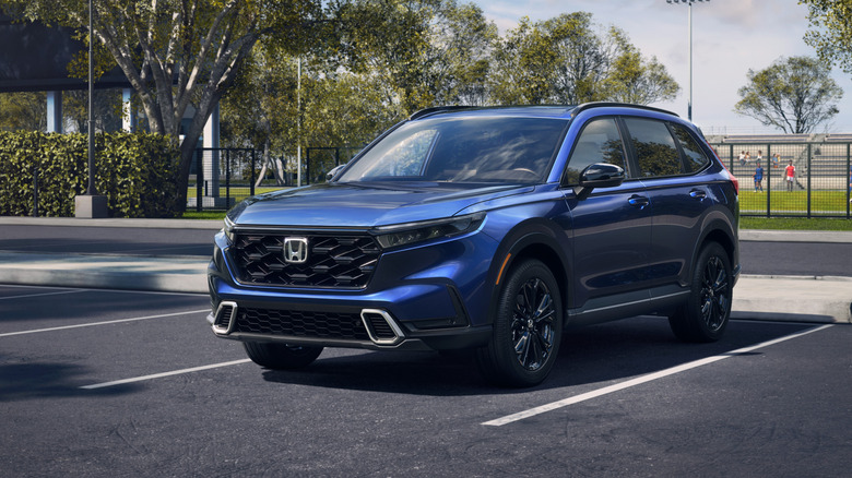 A blue 2026 Honda CR-V Hybrid in a parking lot.