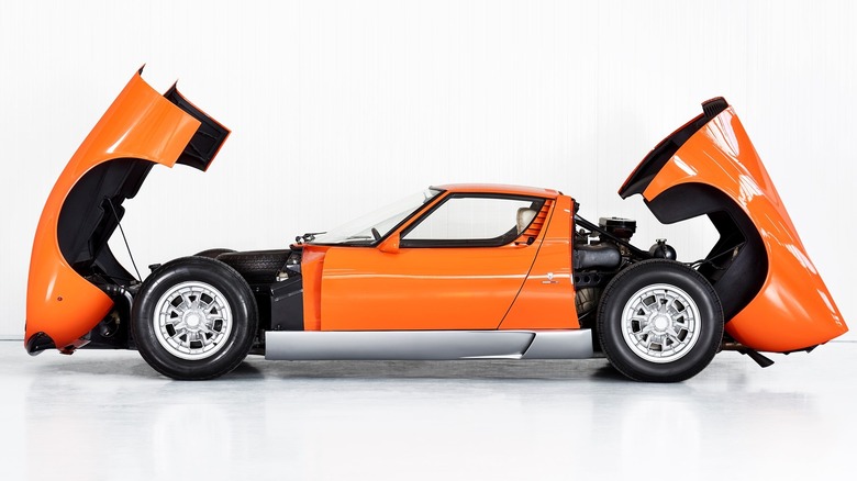 An orange 1969 Lamborghini Miura P400 seen from the side
