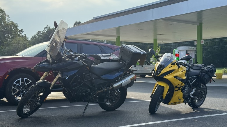 Amber's yellow Suzuki in a parking spot behind a dark blue BMW F800GS