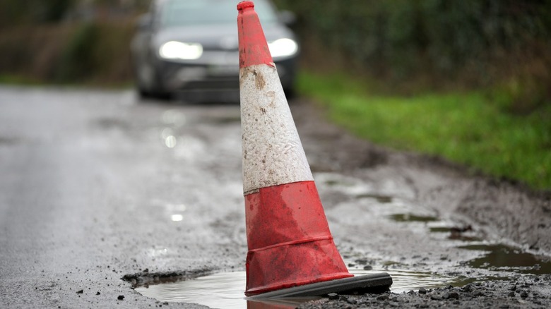 Traffic cone sitting in pothole