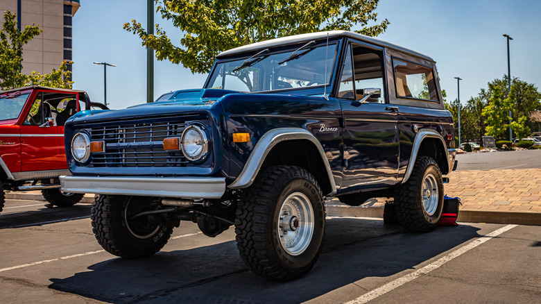 Front 3/4 of a blue first-gen Ford Bronco at a car show.