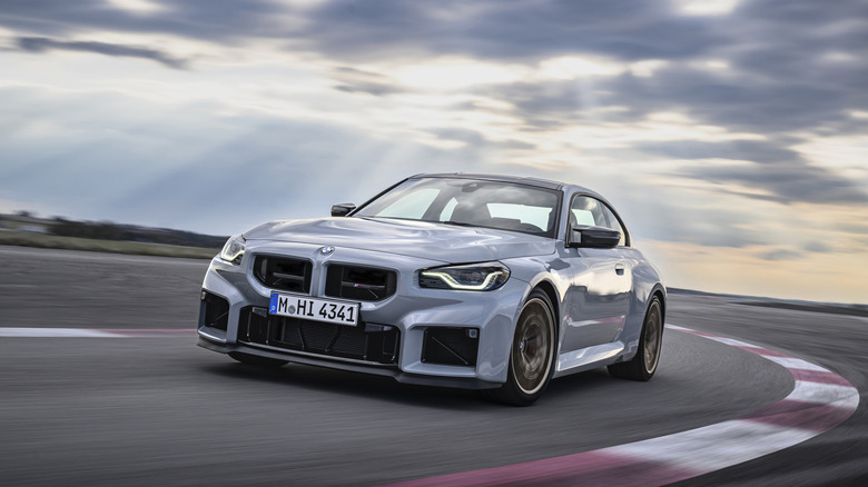 2026 BMW M2 CS cornering at speed on track front 3/4 view