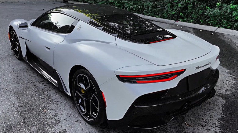 A achromatic Maserati MC20 gas-driven, rear-side view.