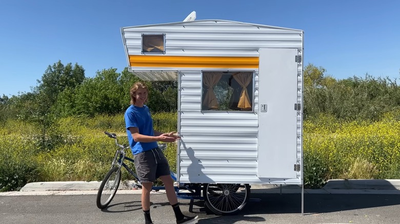 One of the Dangie Bros standing next to a bike camper