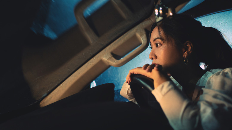 A woman zoned out while sitting in her car