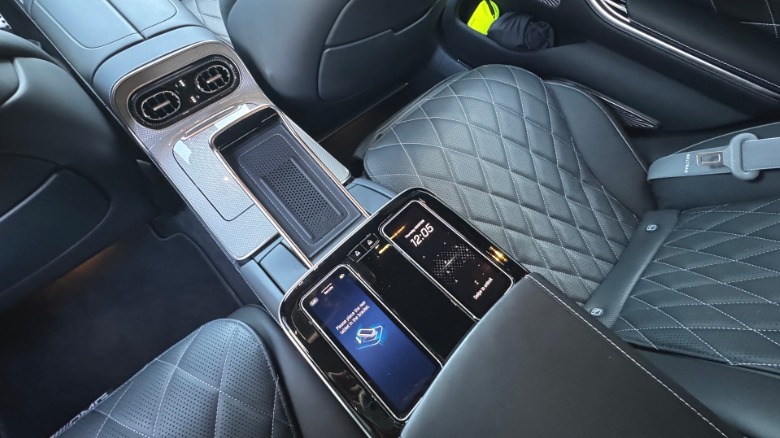 a look at the center console in the rear seat showing the two touchscreen controllers