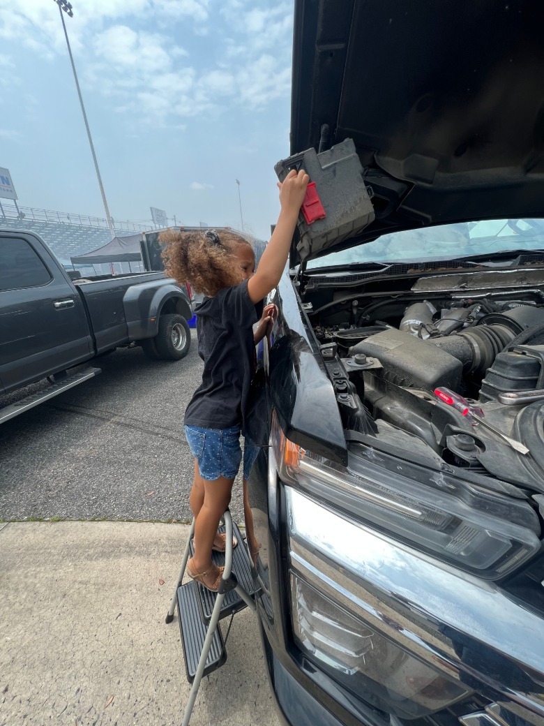 Child holding a car part