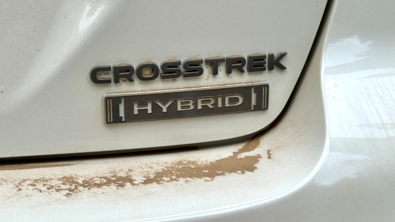 A close up of the rear badge on the veryt dusty white Crosstrek Hybrid