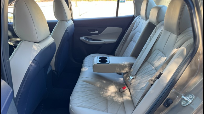 A broadside position of nan rear spot abstraction successful nan Sentra SL pinch quilted achromatic leatherette seats and nan halfway armrest folded down