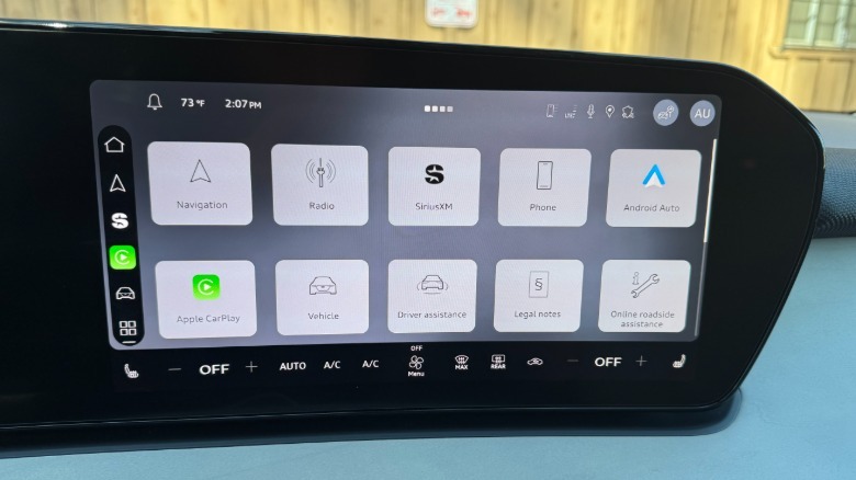 A close-up of the Q3's new infotainment home screen with gray tiles over a darker background