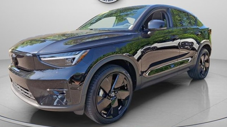 Front three quarters shot of the all black EC40 parked on a gray surface with a gray background