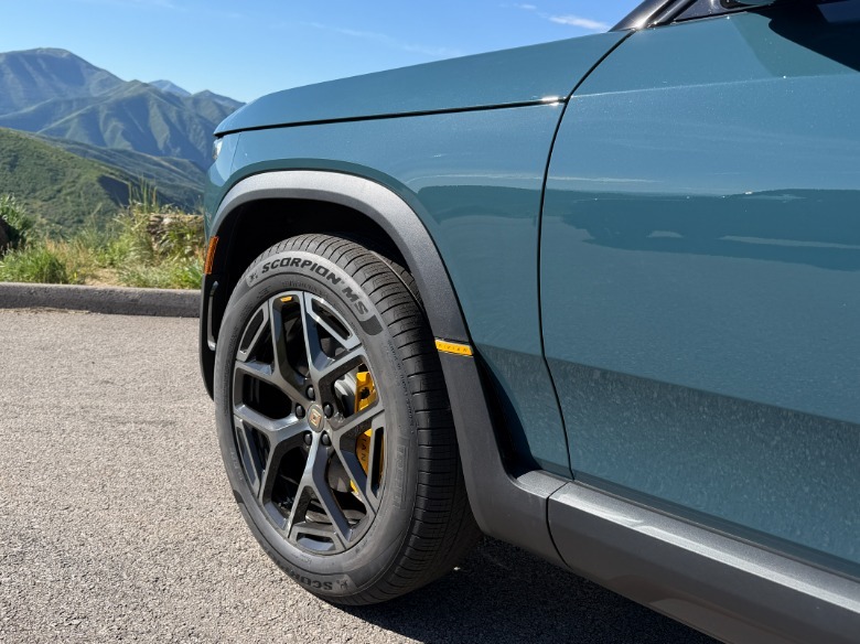 Front wheel of a blue 2027 Rivian R2