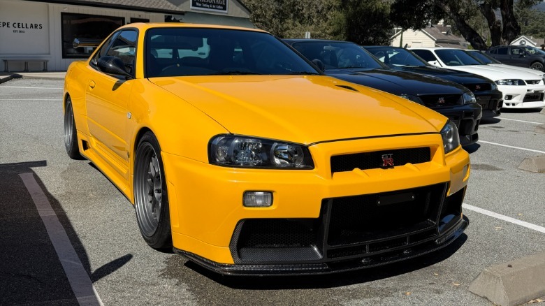 Front 3/4 view of a yellow Nissan R34 Skyline GT-R