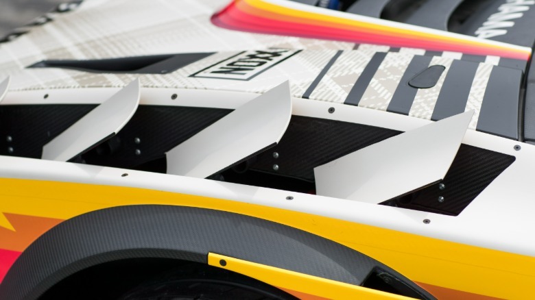 A close-up of the Brataroo's active aerodynamic wings above the front tires