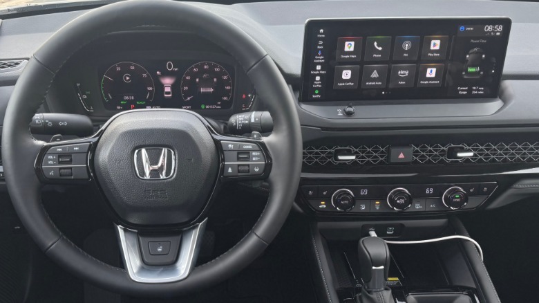 A close-up of the steering wheel and driver's POV inside the Accord Hybrid Touring