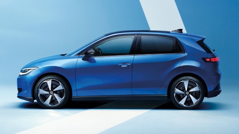 A side view of a blue ID Polo parked in a studio in front of a blue background with a white stripe