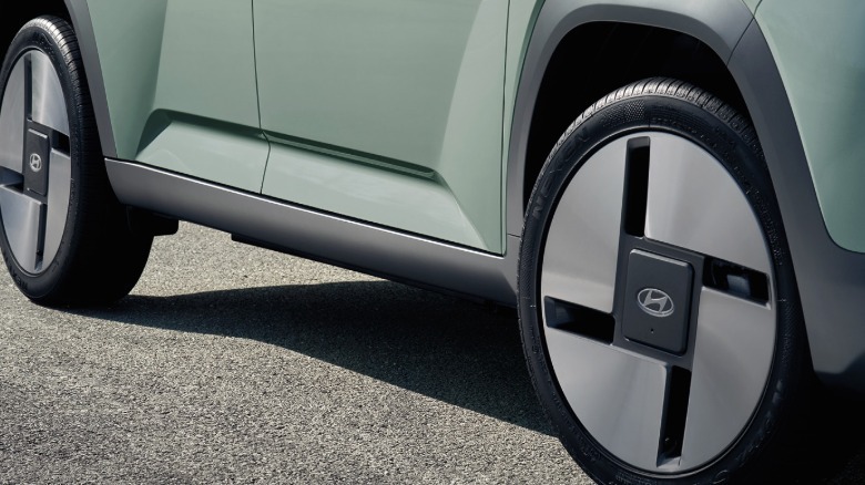 A close-up of the wheels on the mint green Casper Lounge parked on asphalt