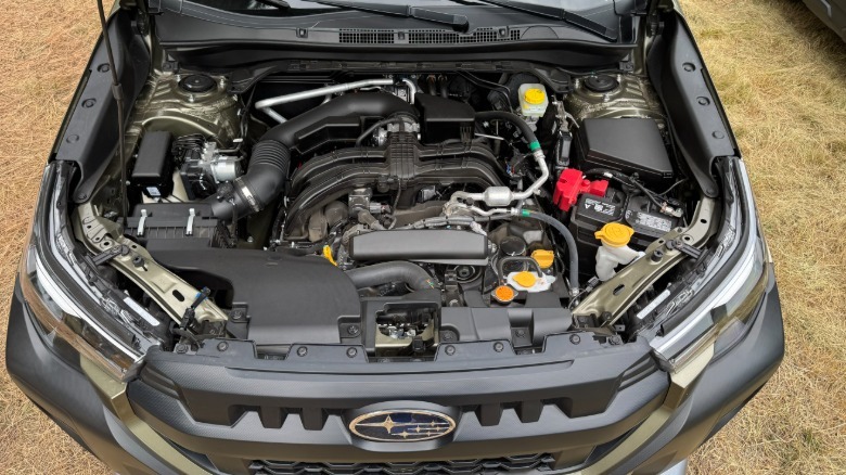 An under hood shot of the Forester WIlderness' engine bay with grass in the background