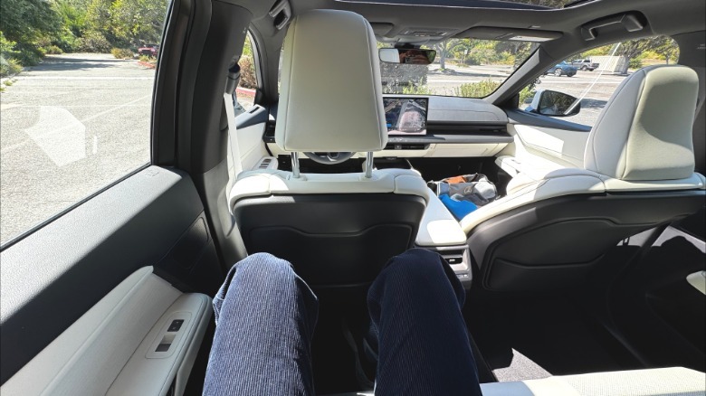 My POV from the back seat of the Lexus ES with a white leather interior showing that I have room between my long legs and the all-the-way back driver's seat