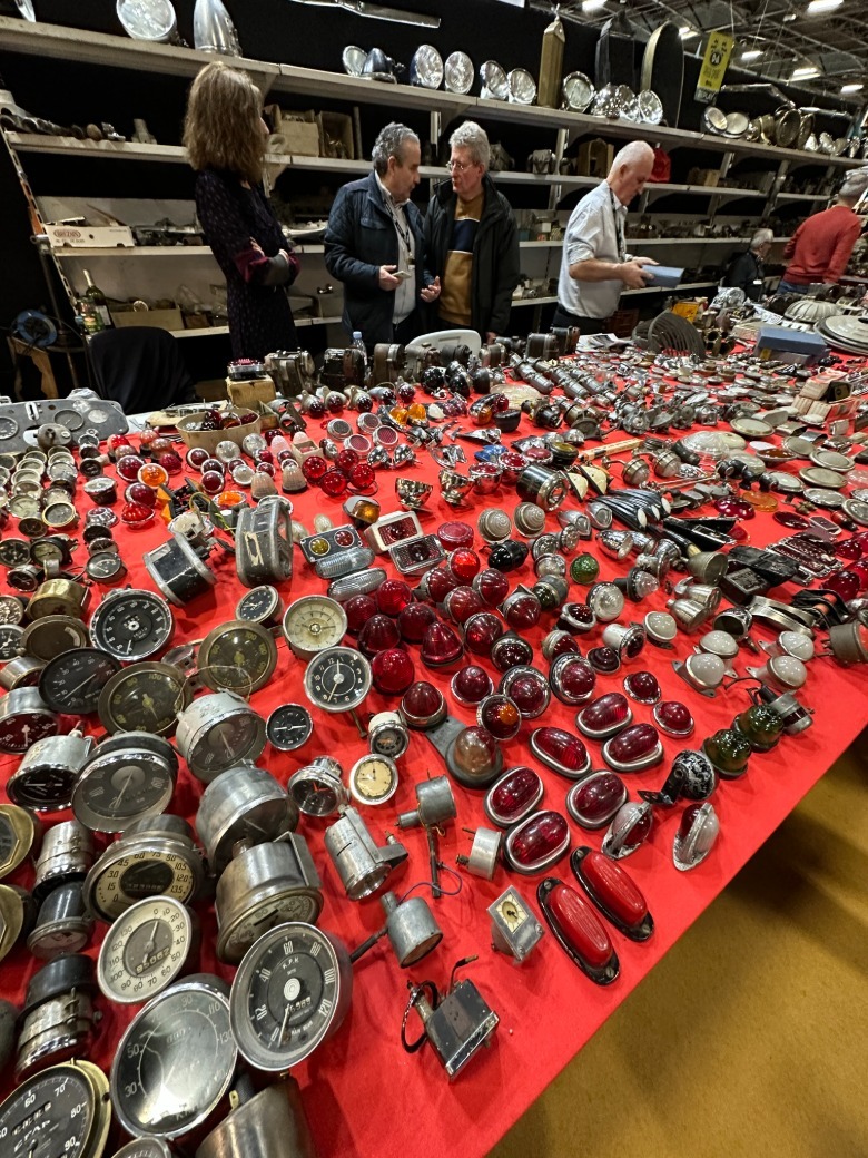 A booth full of taillights and gauge clusters at Rétromobile Paris