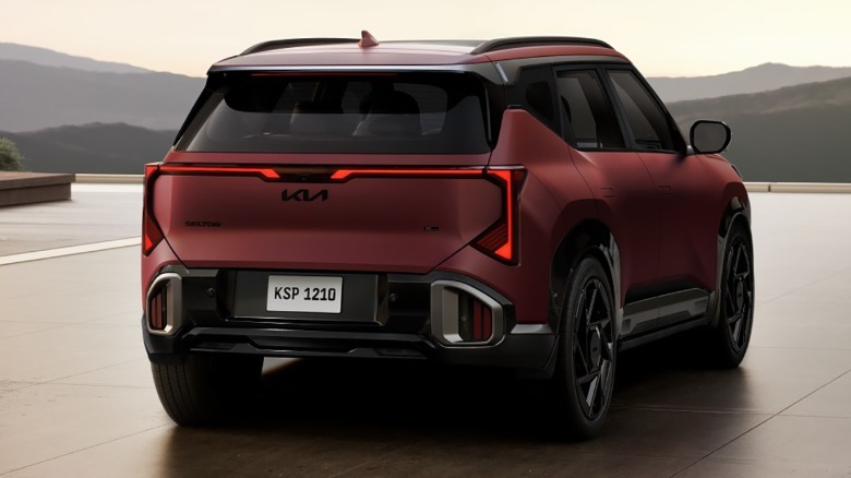 Rear 3/4 view of a matte red Kia Seltos
