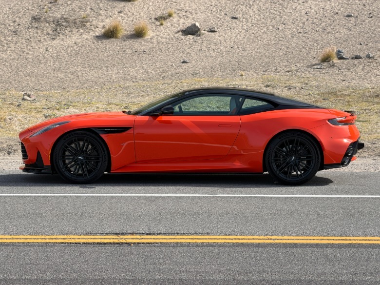 Side view of an orange Aston Martin DB12 S coupe
