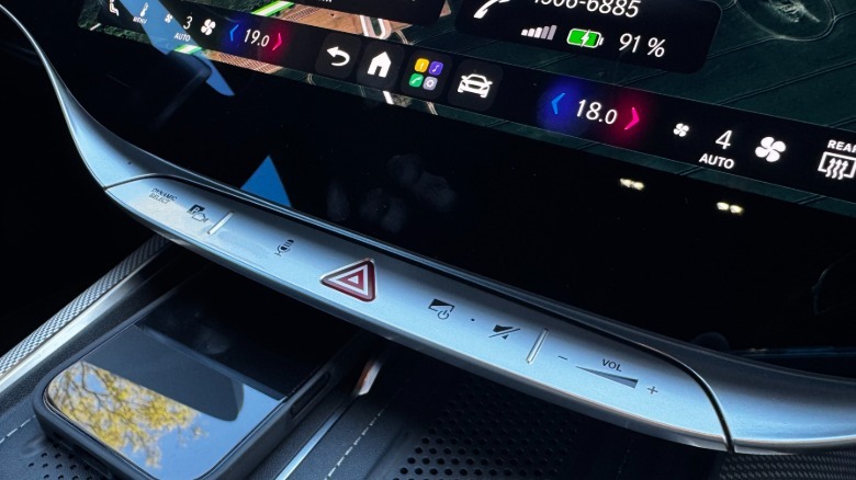 A close-up of the silver-painted touch pad below the center screen